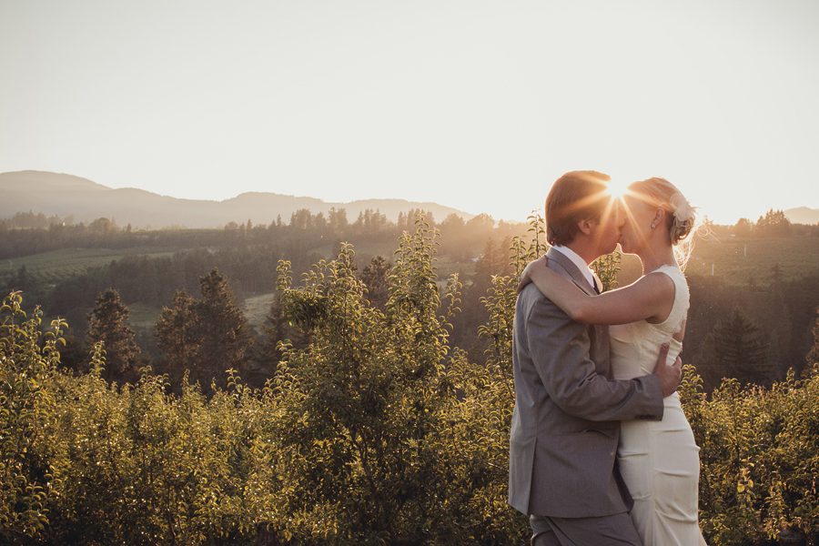 Sunset burst kiss bride and groom wedding photography