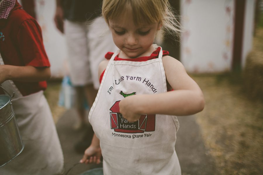 pointing to Little Farm Hands apron at the Minnesota State Fair