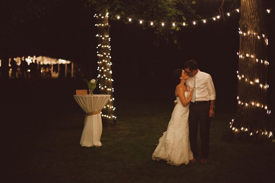 Bride and groom share night kiss outdoor wedding photographer Natalie Champa Jennings
