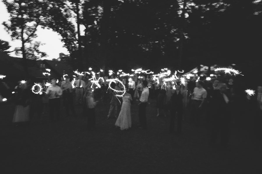 Group lights sparklers at Minnesota Brainerd outdoor wedding