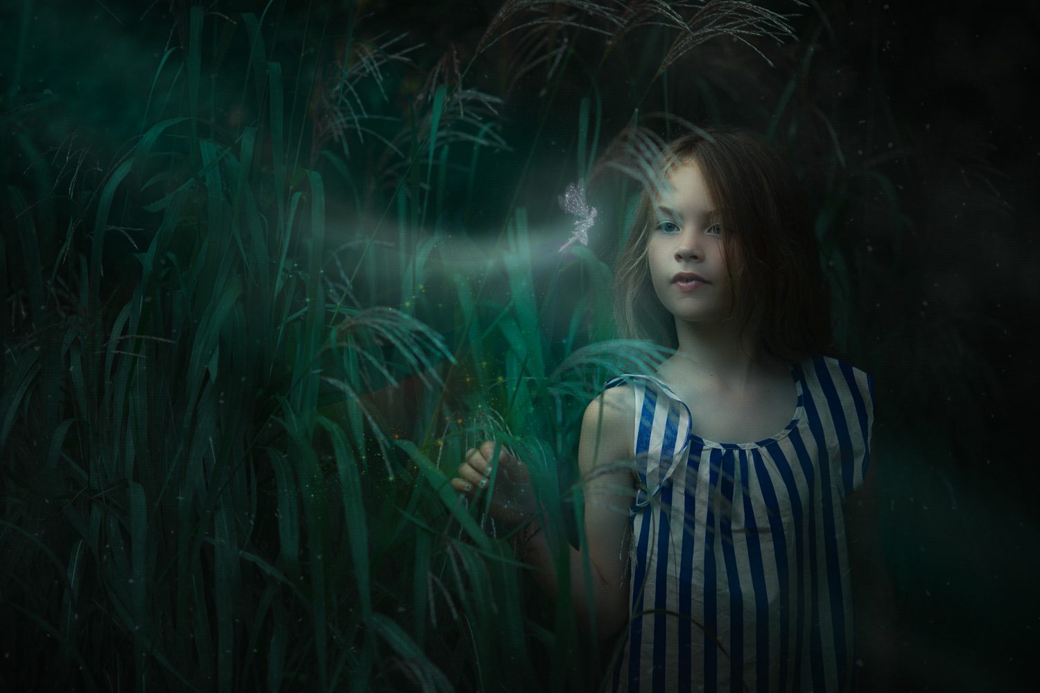 girl in the grass with a fairy flying in front of her conceptual photography jennings photo